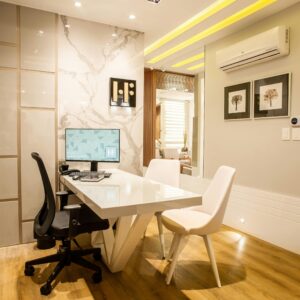 Elegant modern office interior featuring a sleek desk, chairs, and ambient lighting for a sophisticated environment.